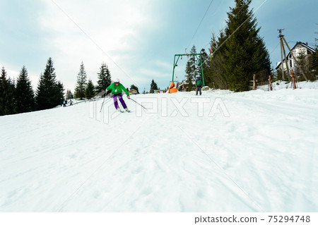 The young guy skis in the Carpathians is not very skillful. The young guy skis in the Carpathians is not very skillful. 75294748