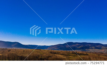 Carpathian village in Ukraine, autumn view of the village, river and mountains from a bird's eye view, aerial photography of the Carpathian region. 75294771