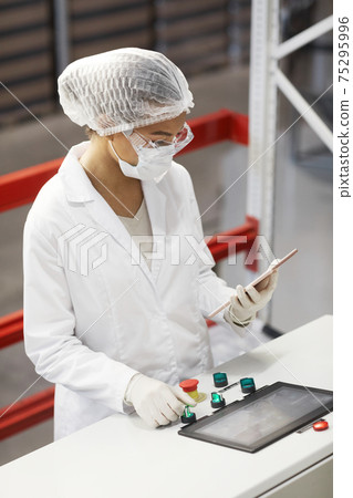Woman Operating Machines at Pharmaceutical Factory 75295996