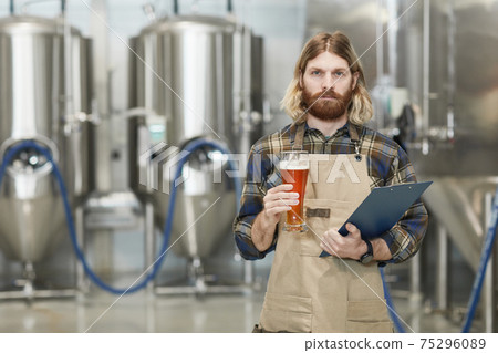 Bearded Brewmaster Holding Beer Glass 75296089