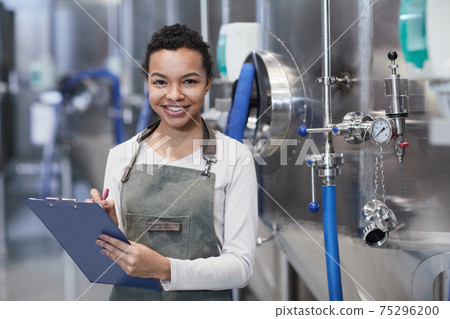 Smiling Young Woman Working at Food Factory 75296200