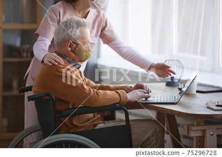 Disabled Senior Man Using Laptop Side View 75296728