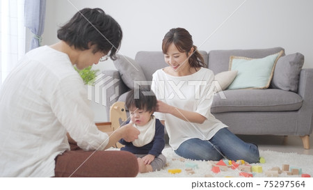 Parents playing with a one-year-old child 75297564