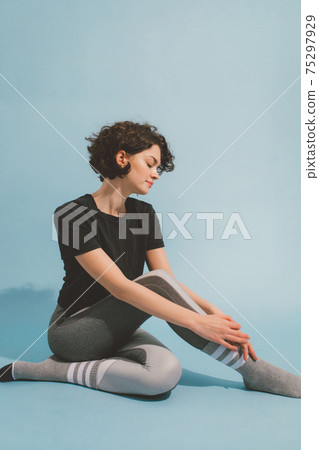 Woman wear stretching her body while practicing yoga at the studio Woman wear stretching her body while practicing yoga at the studio 75297929