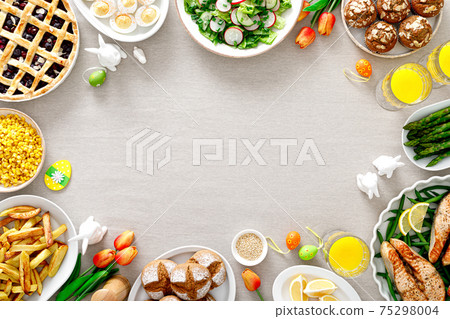 Easter festive table with salmon, asparagus, salad, potato, muffins and berry pie 75298004