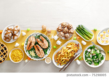 Easter festive table with salmon, asparagus, salad, potato, muffins and berry pie Easter festive table with salmon, asparagus, salad, potato, muffins and berry pie 75298005