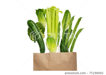 Green vegetables flying from the kraft paper shopping bag isolated on white Green vegetables flying from the kraft paper shopping bag isolated on white 75298082
