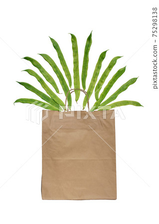 Green flat runner bean pods flying from the shopping bag isolated on white Green flat runner bean pods flying from the shopping bag isolated on white 75298138