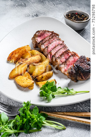 Sliced Grilled rump Beef steak with potato. White background. Top view 75298798