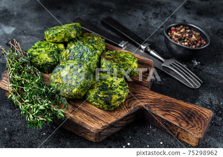 Roasted chickpeas veggie vegetable falafel patty on a rustic plate. Black background. Top view 75298962