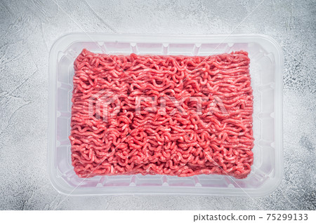 Raw ground beef and pork meat in vacuum packaging from super market. White background. Top view 75299133