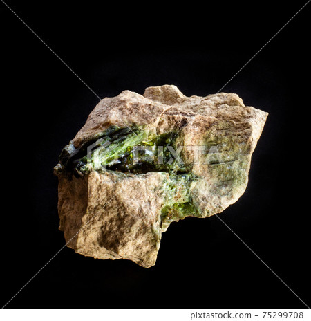 Blotting of green actinolite mineral crystals in rock from Ural, Russia. A backlight photo of a stone isolated on black. Geology websites, stone collection catalog, Natural Science museum wall chart. Blotting of green actinolite mineral crystals in rock from Ural, Russia. A backlight photo of a stone isolated on black. Geology websites, stone collection catalog, Natural Science museum wall chart. 75299708