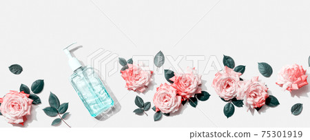 Sanitizer bottle with pink roses overhead view Sanitizer bottle with pink roses overhead view 75301919