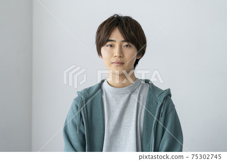 Portrait of a young man looking at the camera 75302745