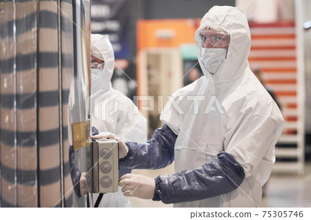 Worker Wearing Protective Suit at Factory 75305746