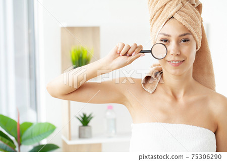 Teen girl with problem skin look at pimple with magnifying glass. Teen girl with problem skin look at pimple with magnifying glass. 75306290