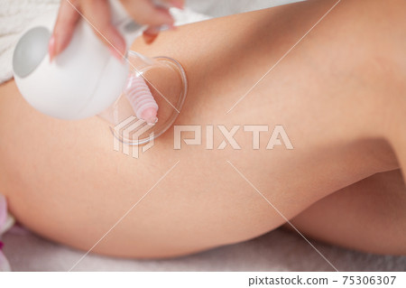Woman getting LPG massage for skin care in home Woman getting LPG massage for skin care in home 75306307