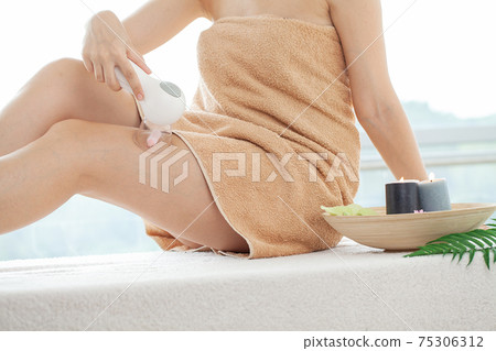 Woman getting LPG massage for skin care in home Woman getting LPG massage for skin care in home 75306312