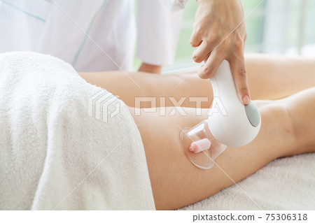 Woman getting LPG massage for skin care in home Woman getting LPG massage for skin care in home 75306318