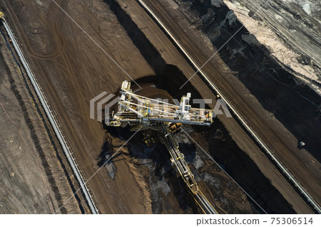 Bucket wheel excavator in a lignite quarry in process, Heavy industry. Bucket wheel excavator in a lignite quarry in process, Heavy industry. 75306514