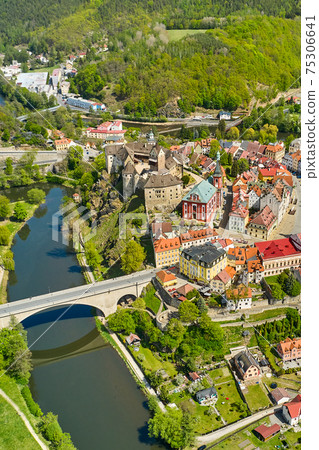 Panoramic view of Loket castle, surrounded by river Ohri and small houses on a river shore, Czech Republic. 75306641