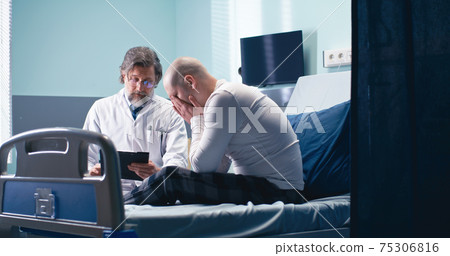 Doctor telling bed news to cancer patient Doctor telling bed news to cancer patient 75306816