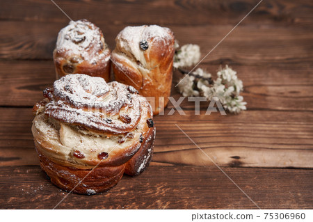 Traditional easter cake Kraffin stands on wooden table against a dark background. Traditional easter cake Kraffin stands on wooden table against a dark background. 75306960