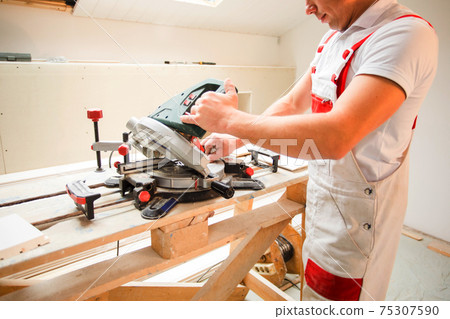 the master works with a special tool is processing boards the master works with a special tool is processing boards 75307590