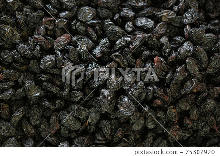Dried black plums background. Dried black plums background. 75307920