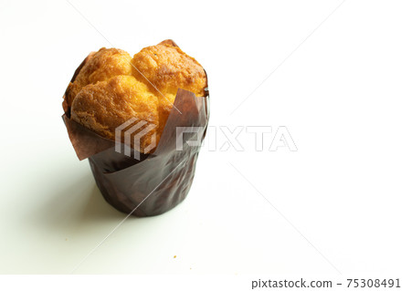 Vanilla cupcake muffin in wrapper on white background isolate. Copy space Vanilla cupcake muffin in wrapper on white background isolate. Copy space 75308491
