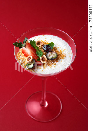 Cup with chocolate mousse dessert with strawberry and mint leaf red background 75308533