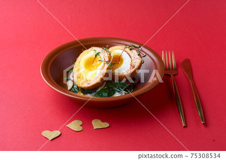 Typical British dish Scotch egg. red background. 75308534