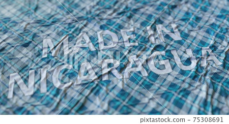 MADE IN NICARAGUA words printed on a cloth, national textile production conceptual 3d rendering 75308691