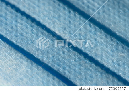 Non sterile 3-ply 4 fold disposable medical face mask macro close up Non sterile 3-ply 4 fold disposable medical face mask macro close up 75309327