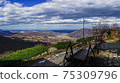 Beautiful spring panaroma over a valley with a wagon infront 75309796