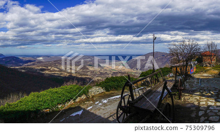 Beautiful spring panaroma over a valley with a wagon infront Beautiful spring panaroma over a valley with a wagon infront 75309796