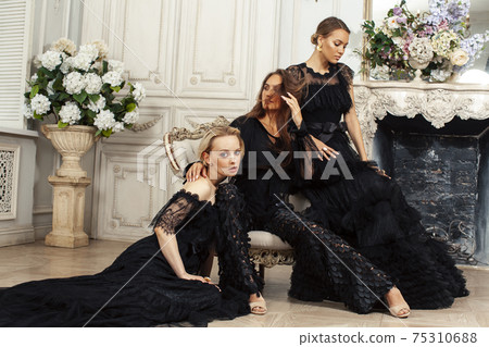 three young pretty lady in black lace fashion style dress posing in rich interior of royal hotel room, luxury lifestyle people concept three young pretty lady in black lace fashion style dress posing in rich interior of royal hotel room, luxury lifestyle people concept 75310688