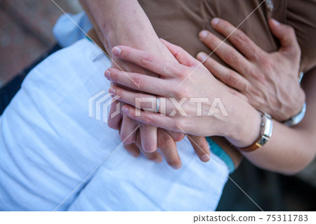 Loving couple holding hands close-up. Love concept Loving couple holding hands close-up. Love concept 75311783