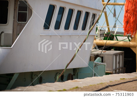 fishing boat stands in port, maritime transport theme  75311903