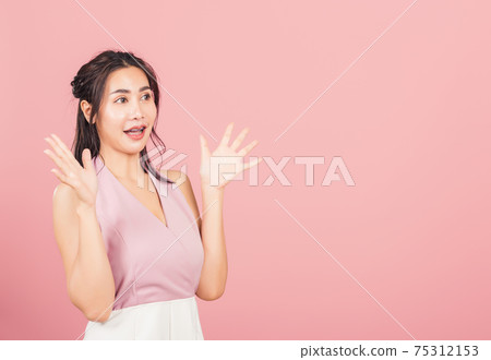 woman standing winning and surprised excited woman standing winning and surprised excited 75312153