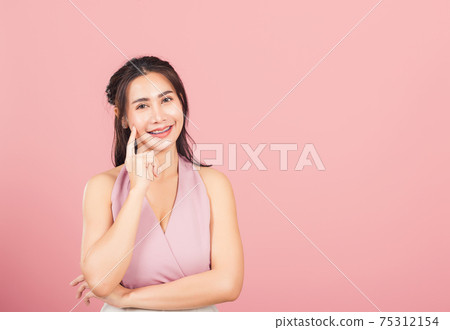 woman smiling standing chin handle relaxed thinking about something about the question woman smiling standing chin handle relaxed thinking about something about the question 75312154