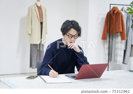 Fashion designer working in the office Fashion designer working in the office 75312962