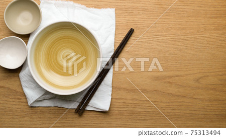 Table Setting Background, mock up ceramic bowls, table cloth and chopsticks on wooden table Table Setting Background, mock up ceramic bowls, table cloth and chopsticks on wooden table 75313494