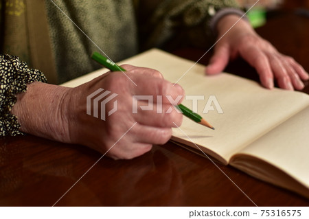Elderly people taking notes 75316575