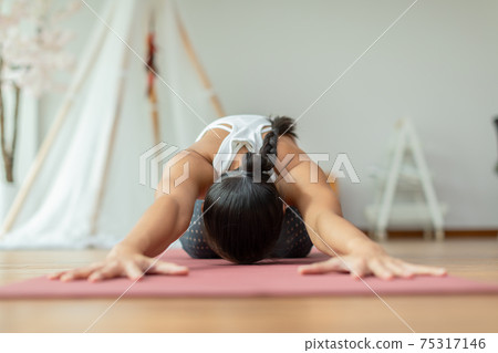 Athletic Asian woman practice yoga Child's pose to meditation in the morning Feeling so calm comfortable and relax,Healthcare and yoga at home Concept Athletic Asian woman practice yoga Child's pose to meditation in the morning Feeling so calm comfortable and relax,Healthcare and yoga at home Concept 75317146