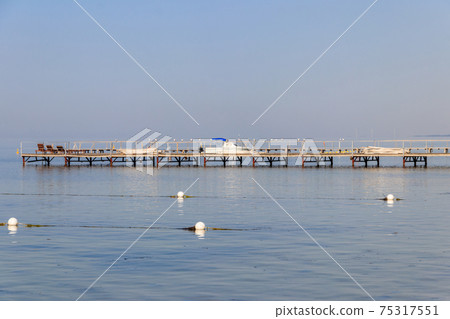 Wooden pier in the Black sea in Skadovsk, Ukraine Wooden pier in the Black sea in Skadovsk, Ukraine 75317551