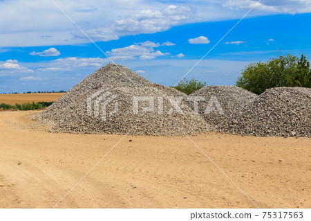 Piles of gravel for road construction Piles of gravel for road construction 75317563