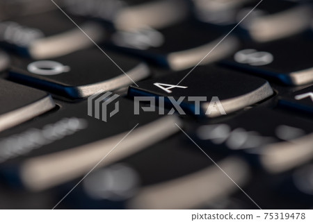 Macro shot of black keyboard focus on A key Macro shot of black keyboard focus on A key 75319478