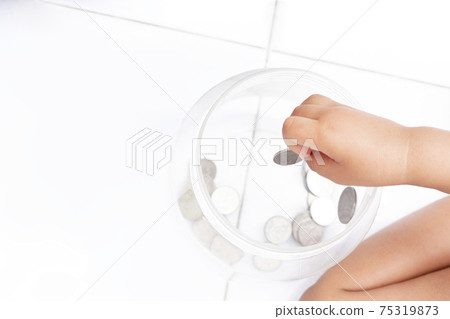 kid's hand picked up Thailand coin to jar kid's hand picked up Thailand coin to jar 75319873