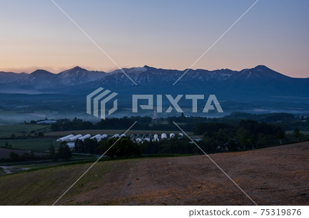 Scenery of Kamifurano Town and Tokachidake Mountain Range in summer 75319876